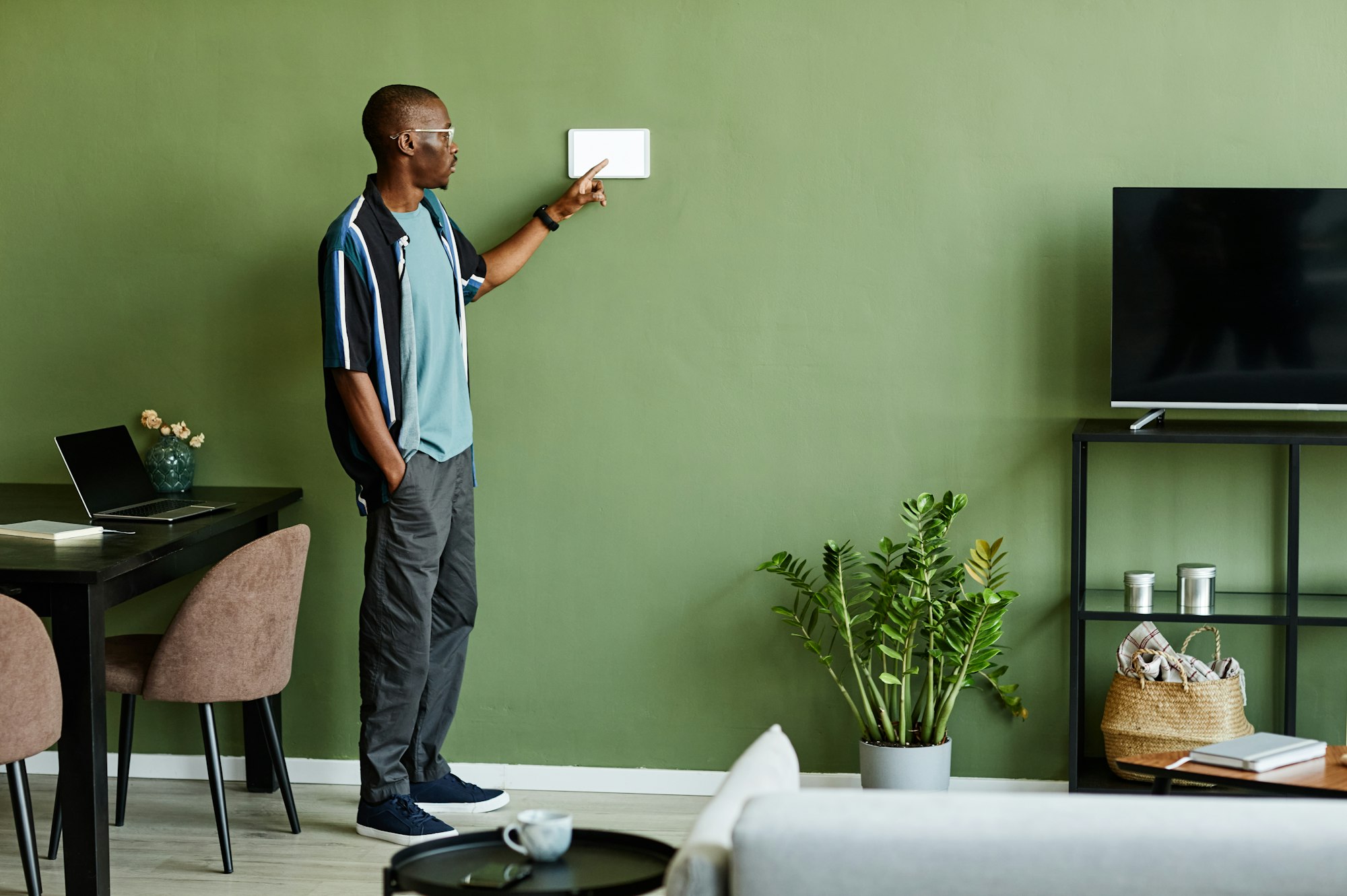African American Man Operating Smart Home System