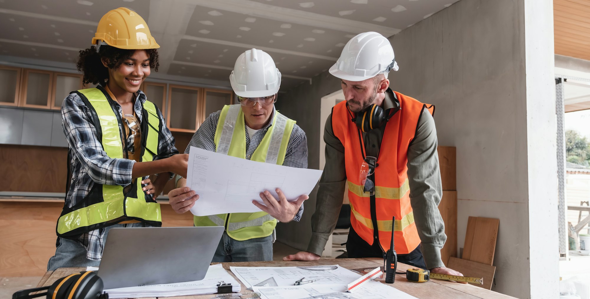 Civil engineer teams meeting working together wear worker helmets hardhat on construction site in