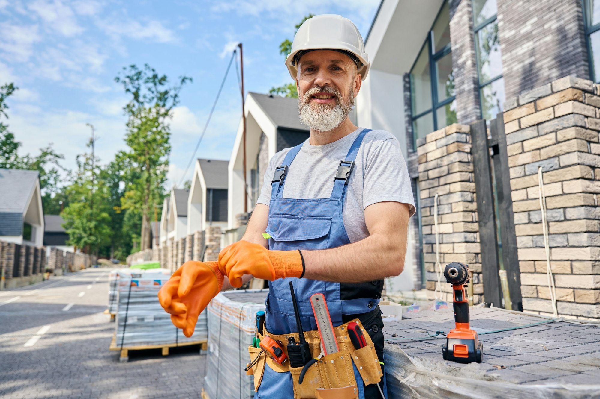 Pleased builder preparing for masonry work on building site